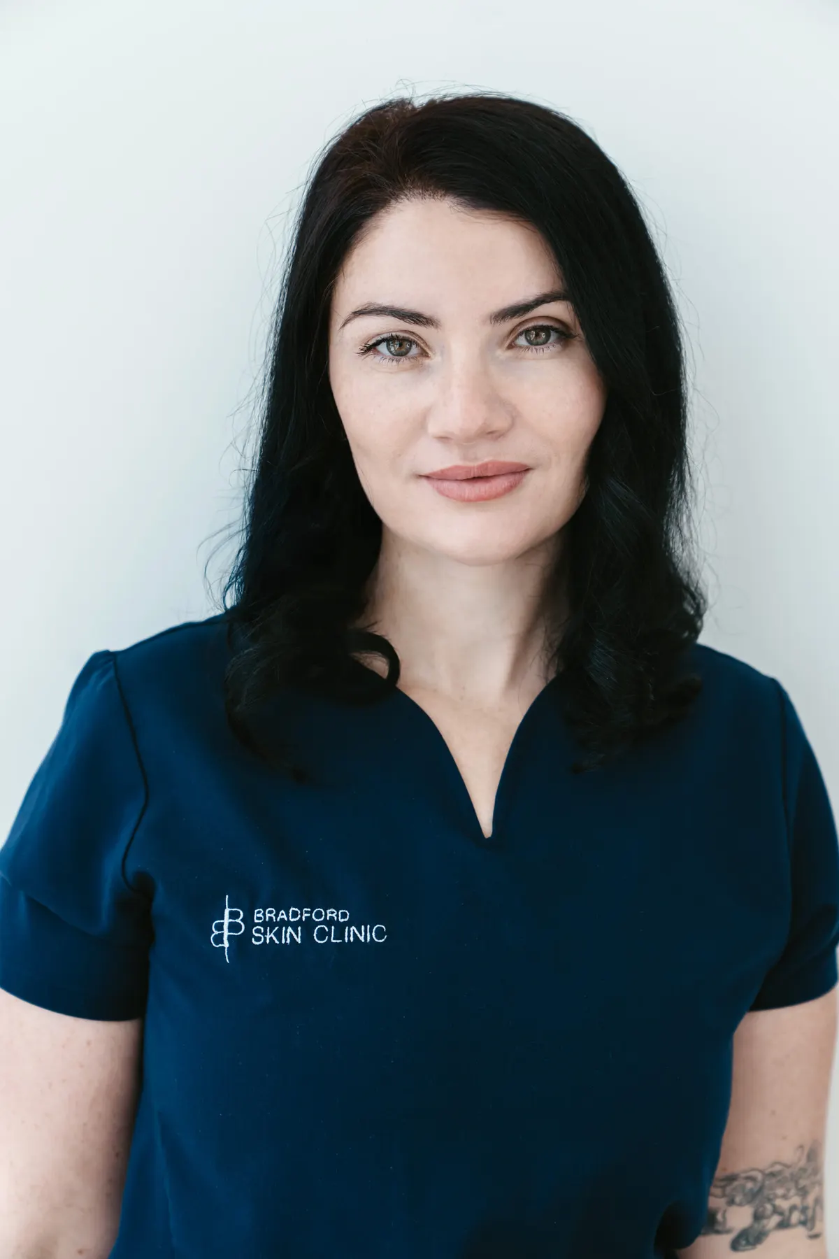 Alex Dinovich in navy Bradford Skin Clinic scrubs