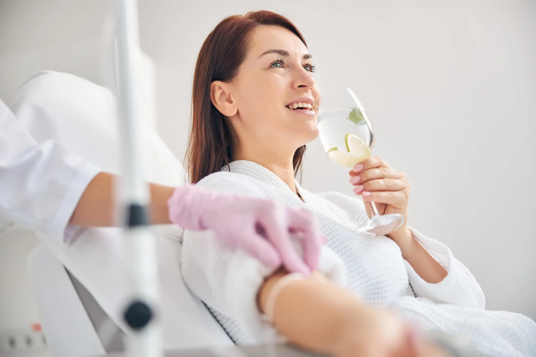 A client resting comfortably with an intravenous drip running during a wellness appointment