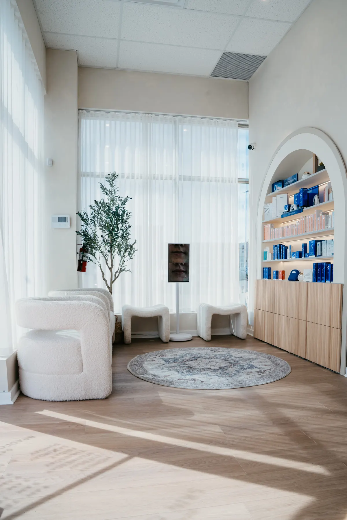The Bradford Skin Clinic waiting area, with the arched retail shelving and seating